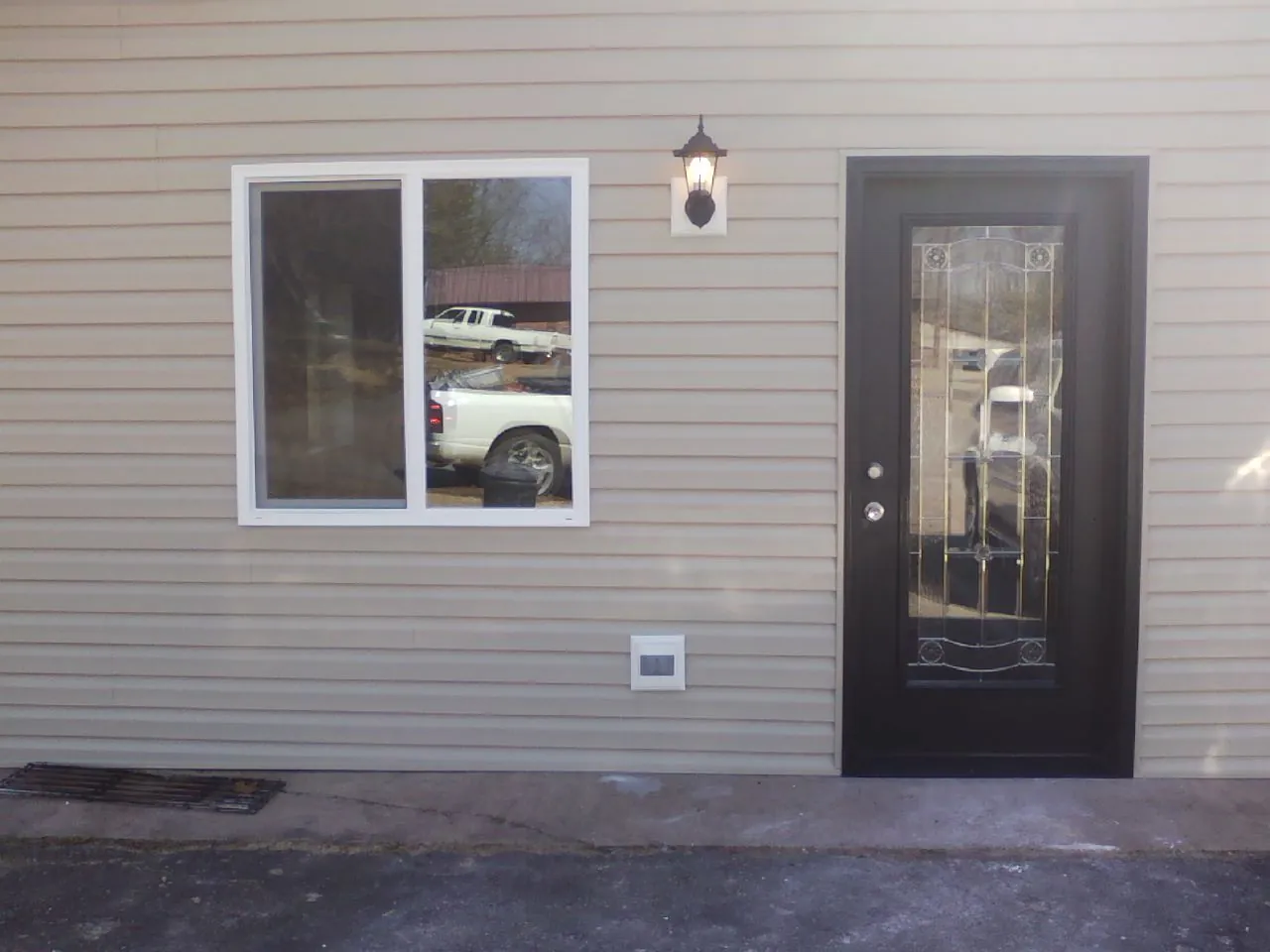 New siding, window and entry door on the side of an addition in Gales Creek