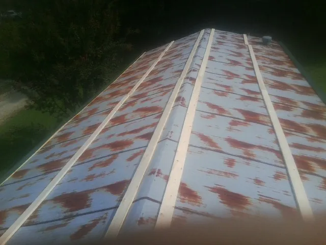 Rusted metal roof panels with new wood purlins before replacement — Storm Damage Roof Repair in Gales Creek by Roofing Brothers